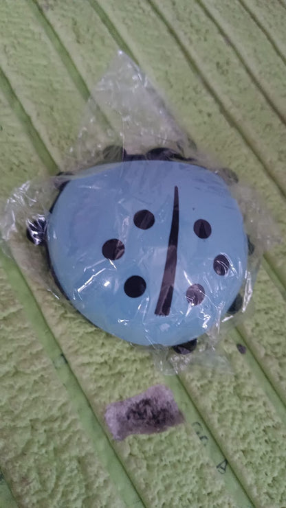 Blue ladybug toothbrush holder packaged in clear plastic for bathroom decor