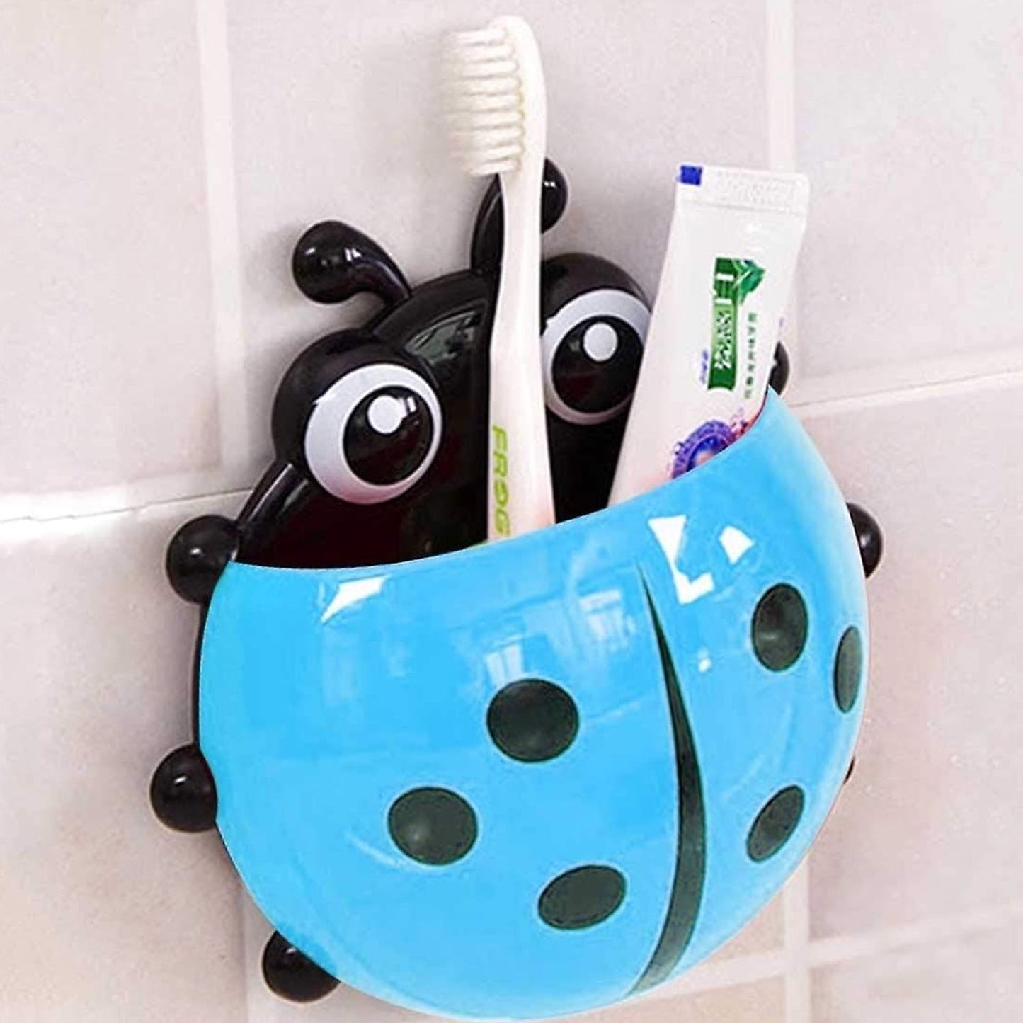 Cute ladybug toothbrush holder in blue with toothbrush and toothpaste for bathroom organization