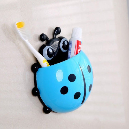 Cute ladybug toothbrush holder in blue, perfect for storing toothbrushes and toothpaste in kids' bathrooms