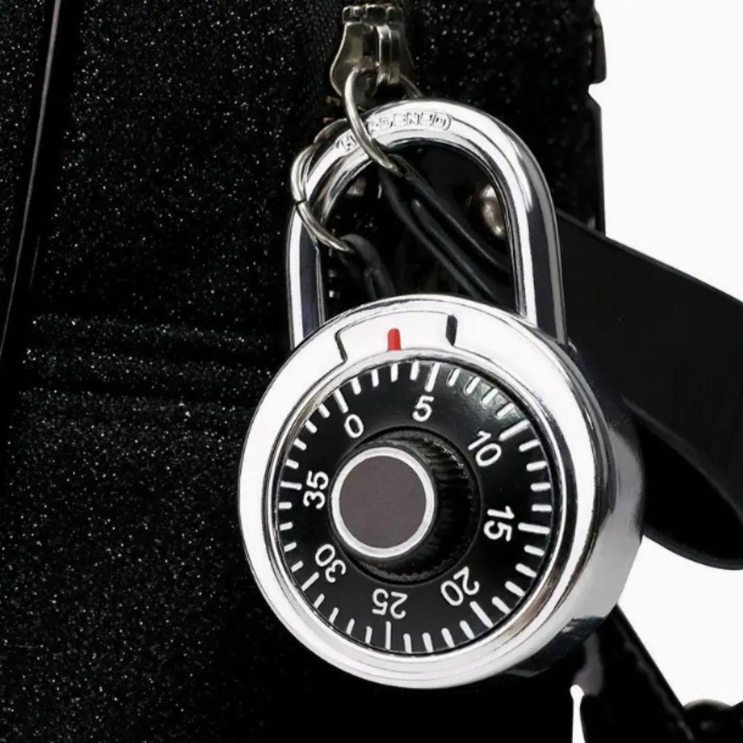 THE GIR FARMER standard dial combination lock with black dial and silver body attached to a black bag