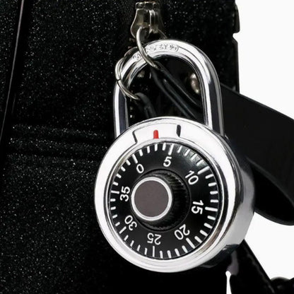 THE GIR FARMER standard dial combination lock with black dial and silver body attached to a black bag