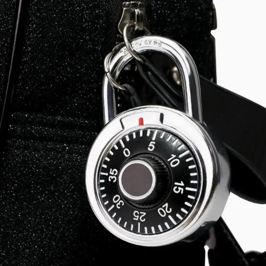 THE GIR FARMER standard dial combination lock with black dial and silver body attached to a black bag