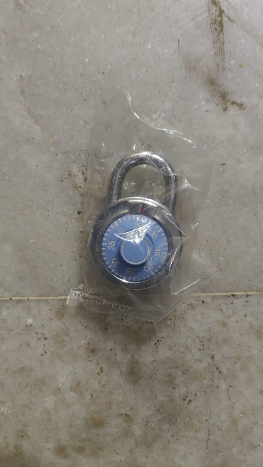 THE GIR FARMER standard dial combination lock with blue dial encased in plastic packaging
