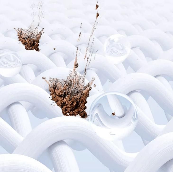 Closeup of white woven fabric with dirt splashes and water droplets showing cleaning action of color bleach laundry detergent