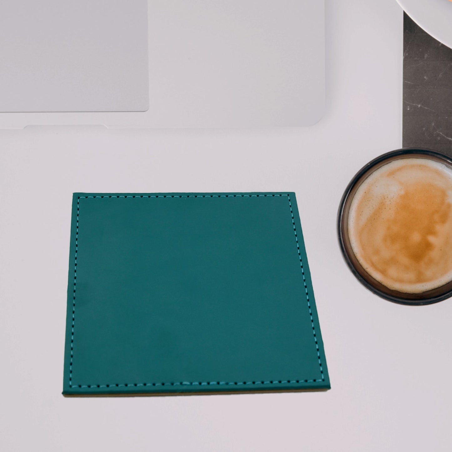 Turquoise leather tea coaster placed beside a coffee mug on a desk