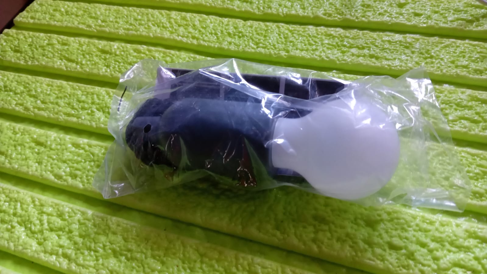LED pull cord light bulb packaged in plastic for easy installation in various settings