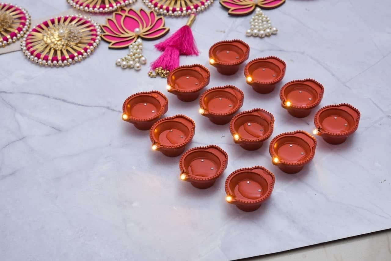 Set of LED water sensor diyas glowing on a decorative surface for festive celebrations