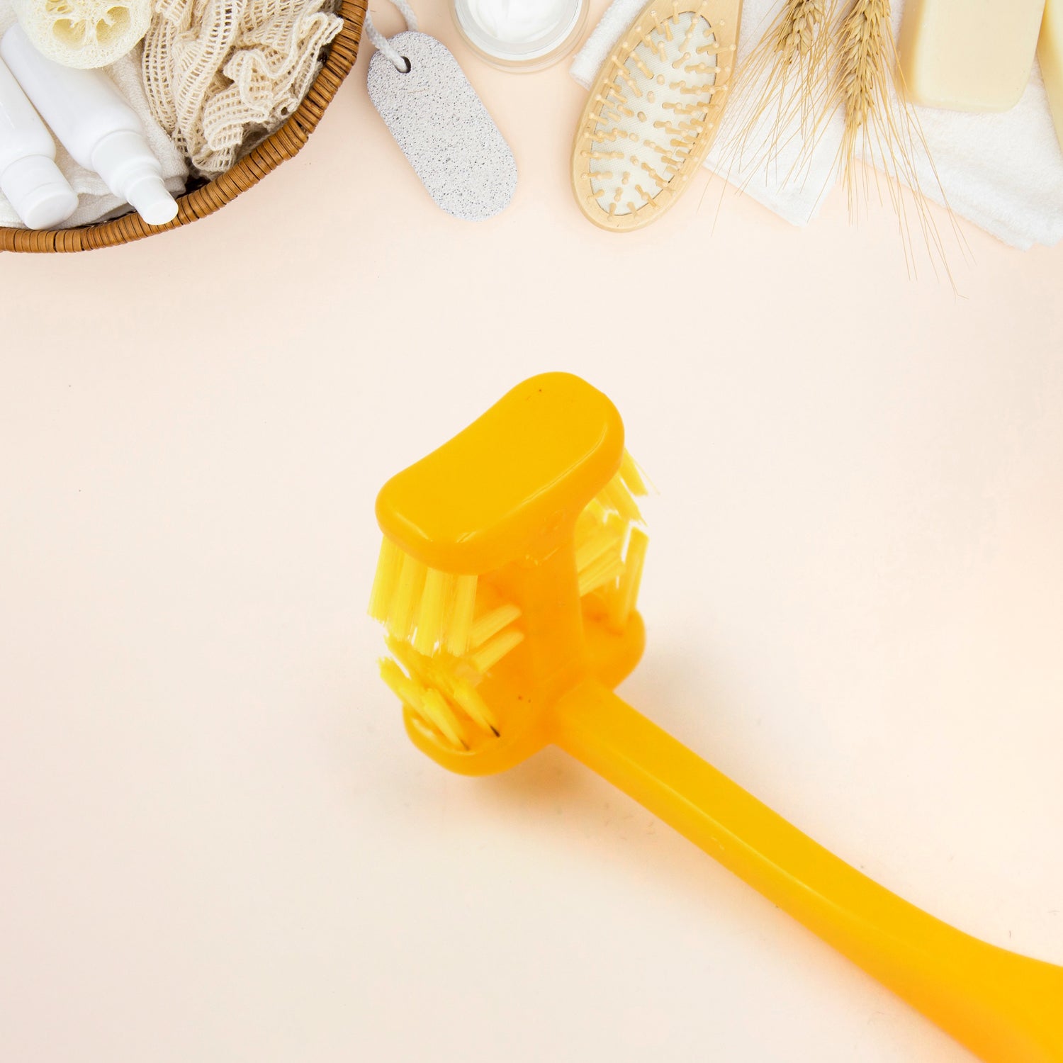 Bright yellow six sided soft toothbrush for gentle dental care on a personal care background