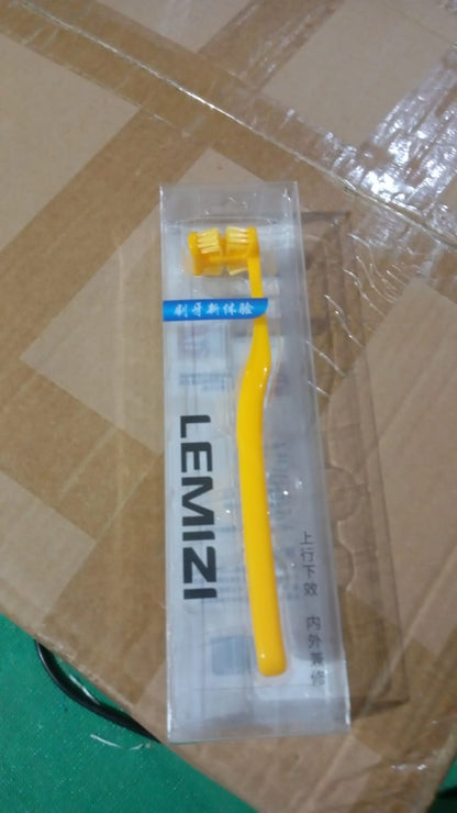 Yellow six sided soft toothbrush in packaging for gentle and effective oral care