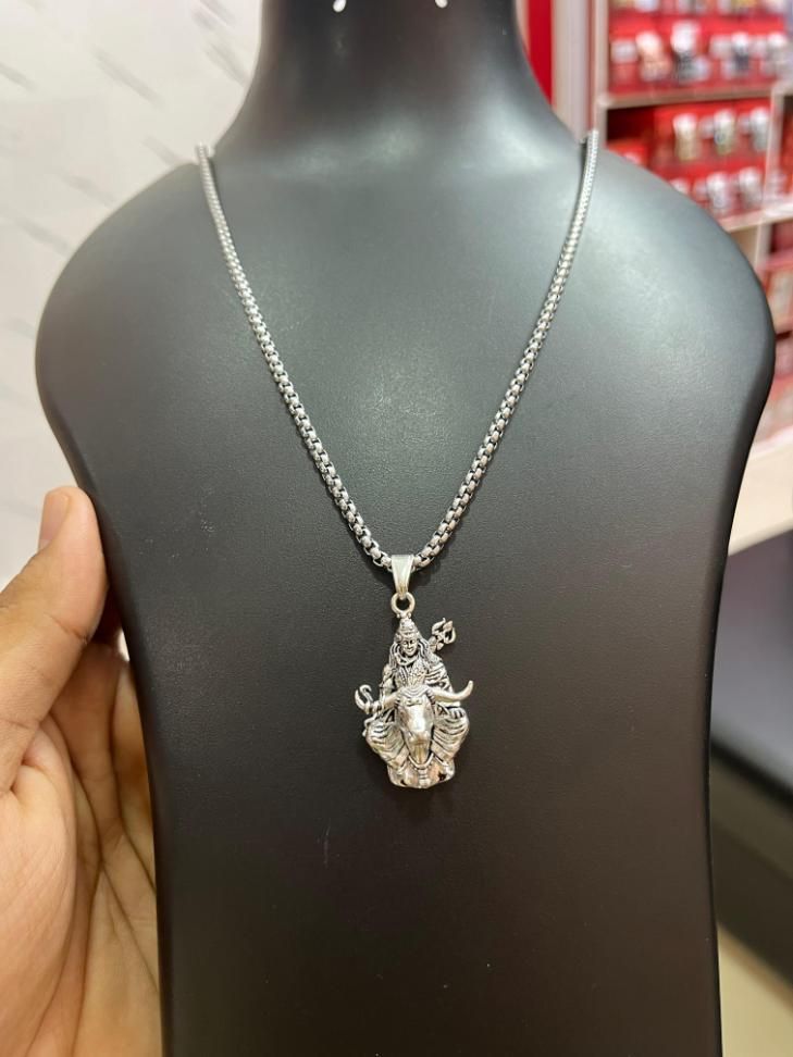 Lord Shiva silver pendant on a sleek chain displayed on a black bust for jewelry showcase