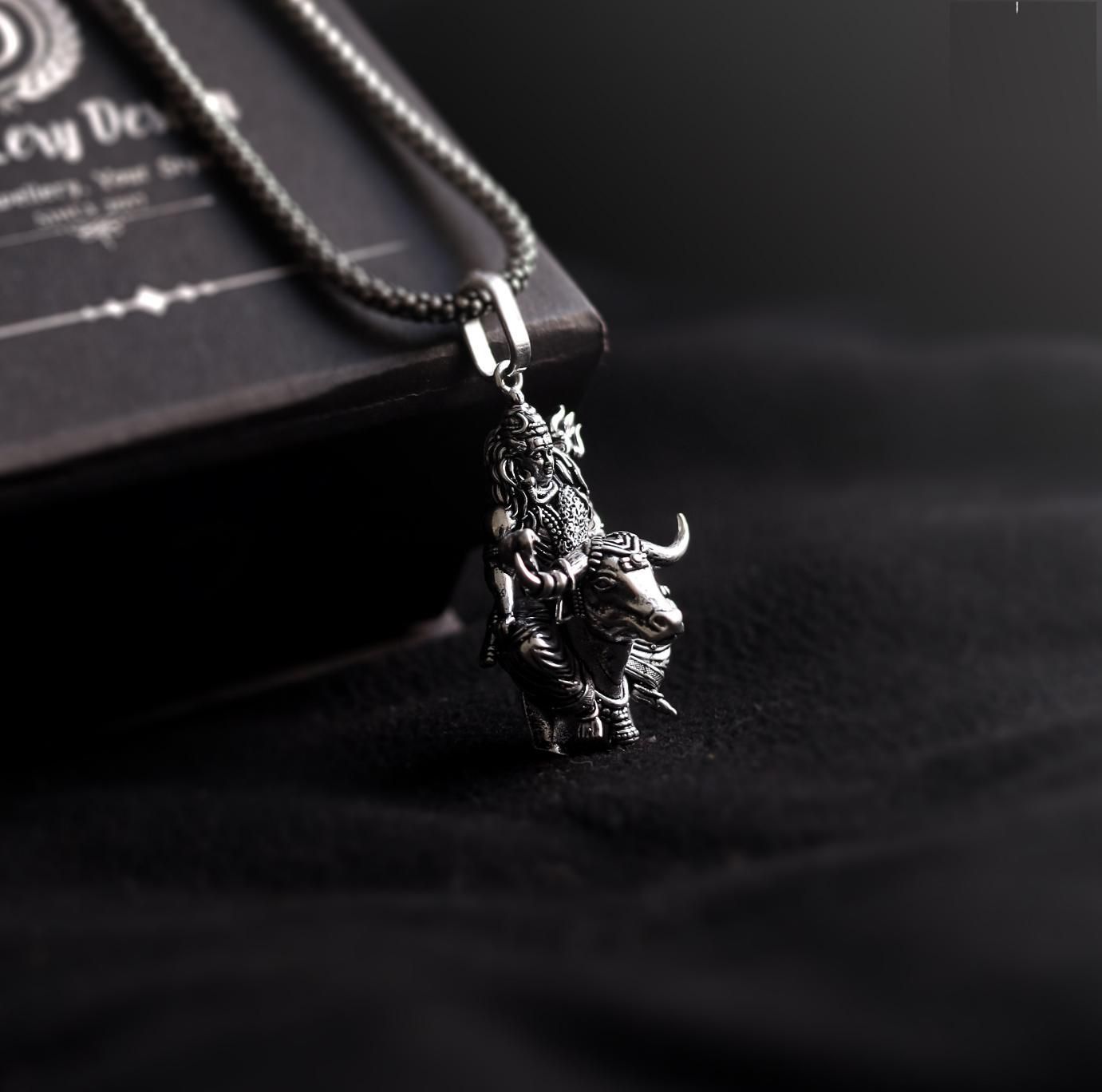 Lord Shiva silver pendant featuring intricate design with a bull motif on a sleek chain