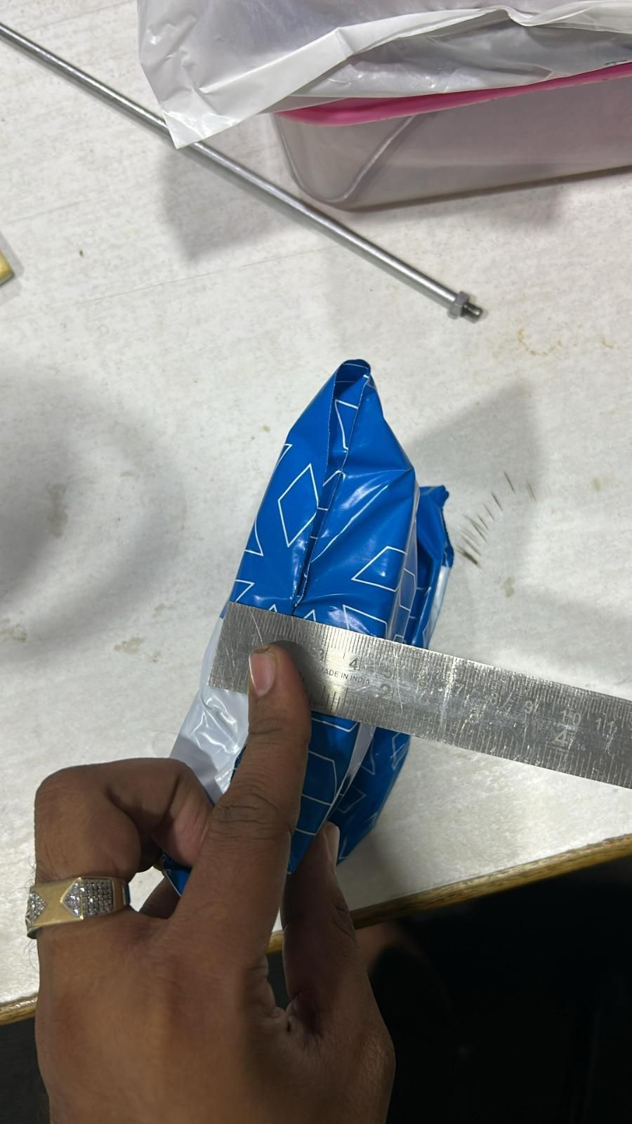 Unboxing a package of magnetic eyelashes pair being cut open with a ruler on a table