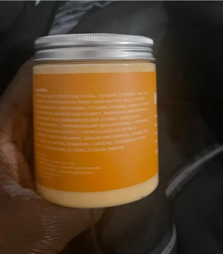 Organic body care hot cream in a sleek jar with detailed ingredients list on the label