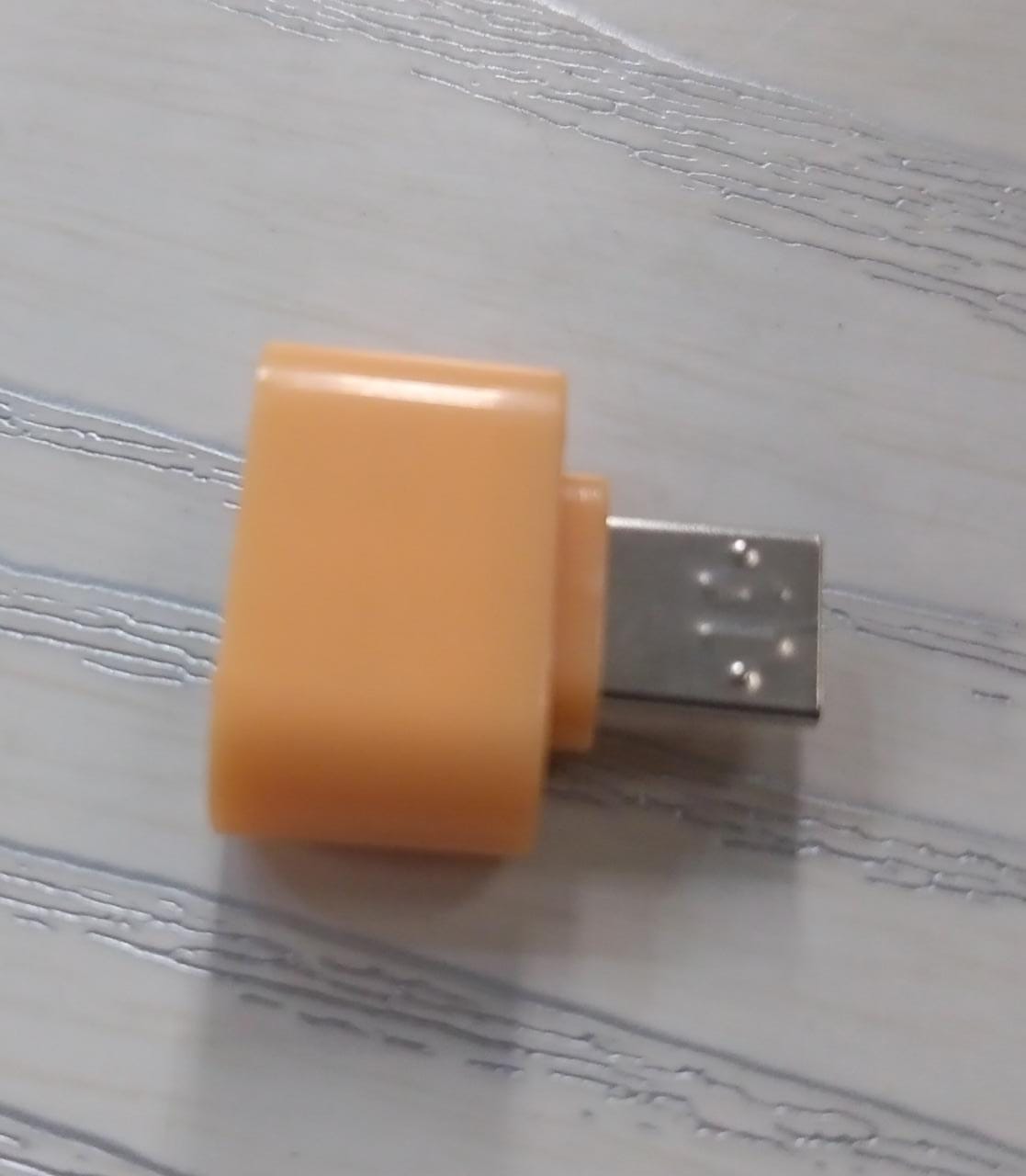 Micro USB OTG adapter for Android in a compact orange design for easy connectivity