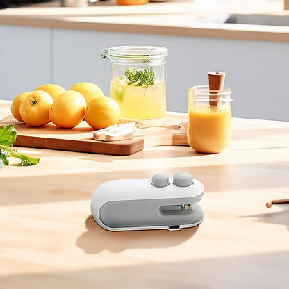 Your Brand mini bag sealer for snacks on a kitchen counter with fruits and beverages