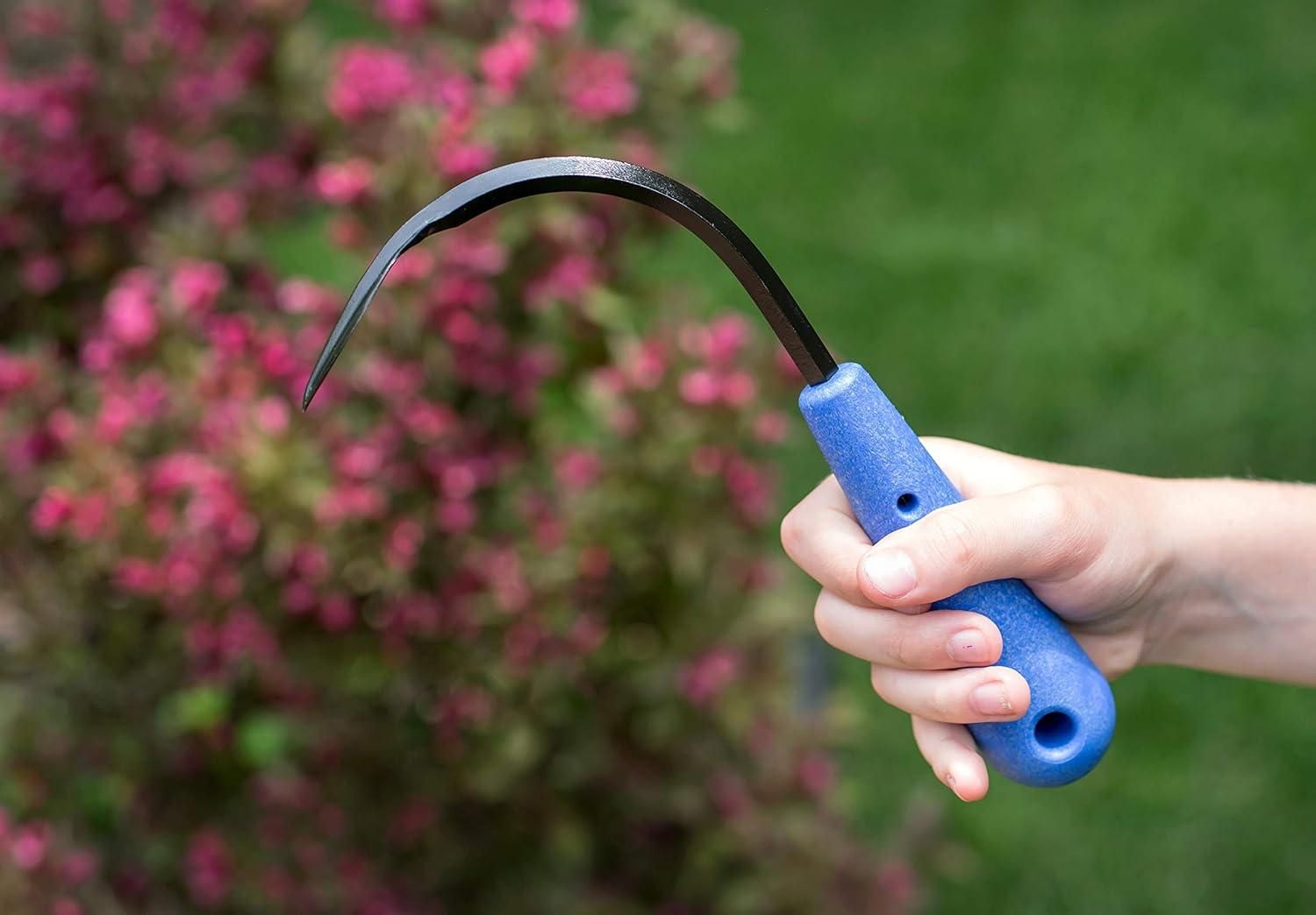 Hand holding mini weeder pack for raised beds with blue handle and curved metal blade outdoors