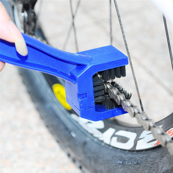 Motorbike chain cleaning brush in use, efficiently removing dirt and grime from a motorcycle chain