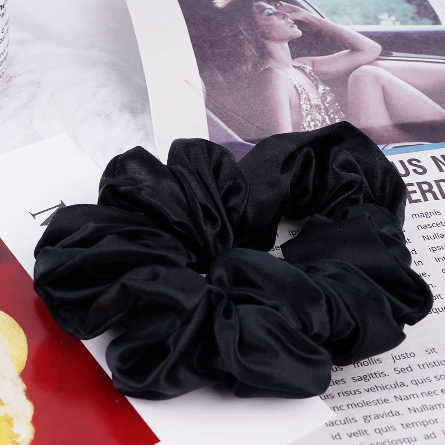 Black mulberry silk elastic band for hair by Amd-Deodap placed on magazine pages