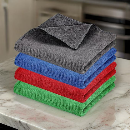 Set of colorful microfiber cloth for household cleaning stacked on marble countertop by THE GIR FARMER