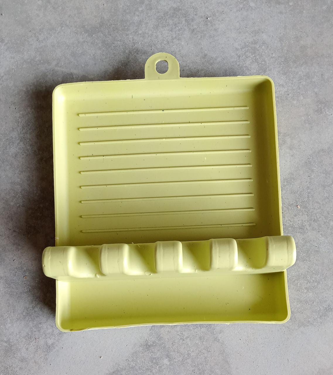 Green multi-functional spatula holder with grooves for organizing cooking tools in the kitchen