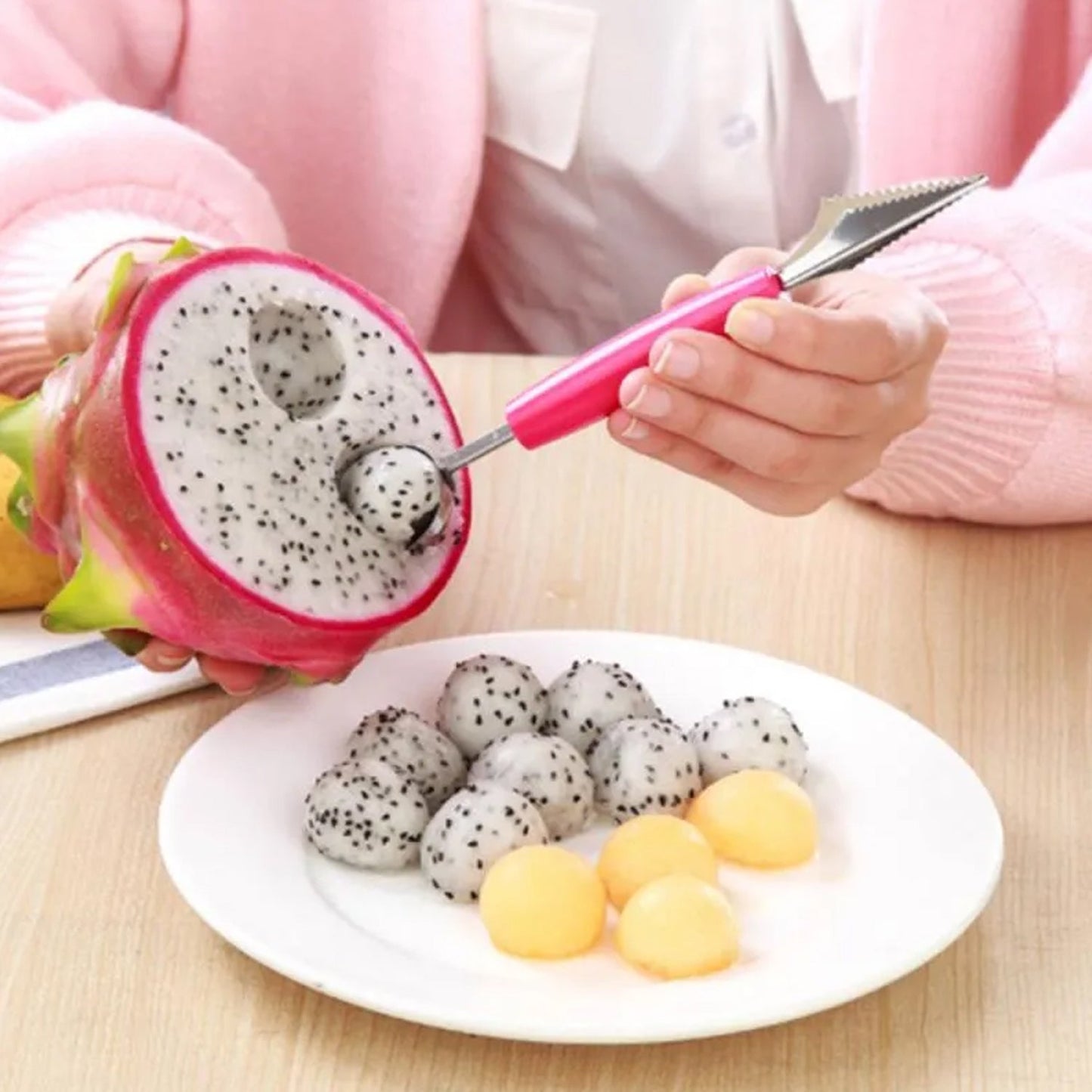 Quickslice multifunctional fruit scooper extracting round fruit balls from a dragon fruit on a plate