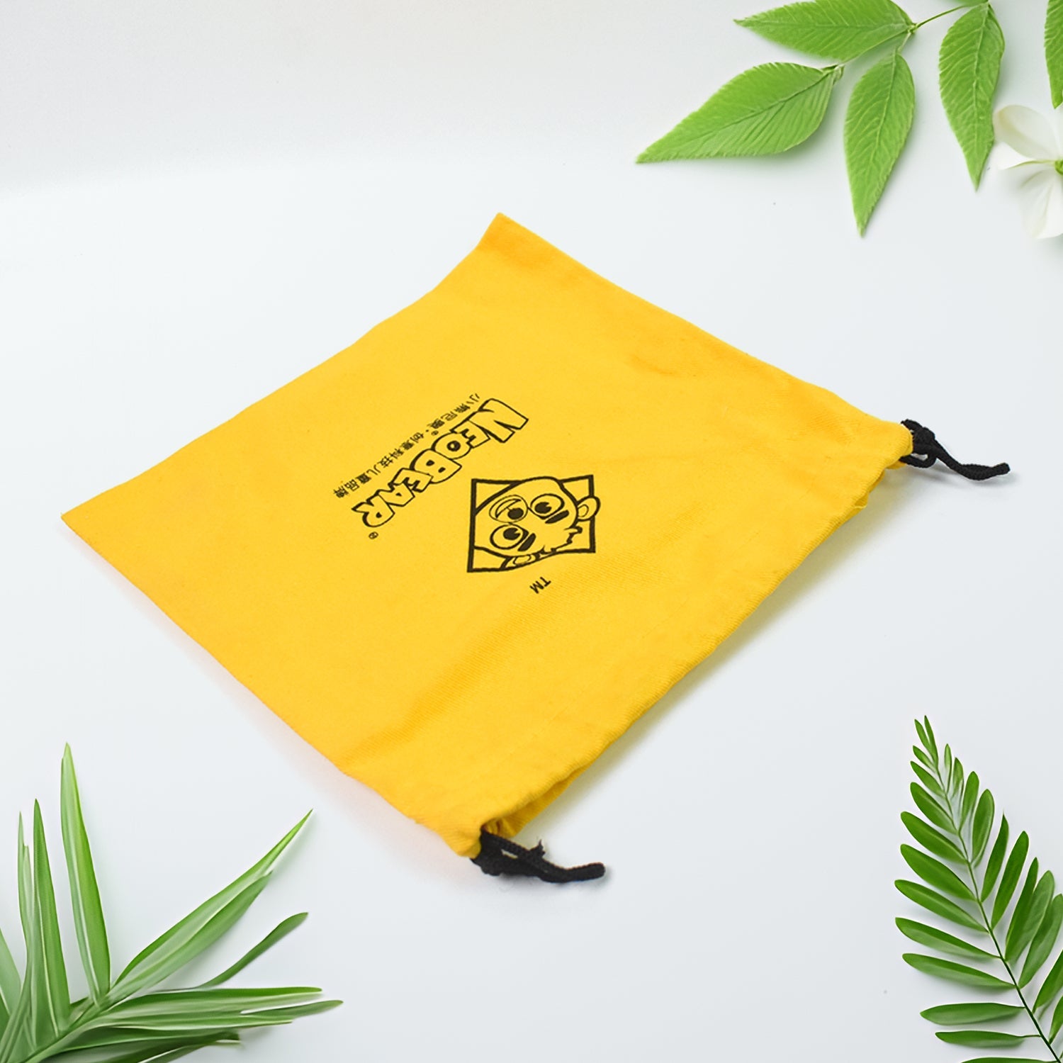 Heavy duty small dori bag in bright yellow with a fun logo for versatile use