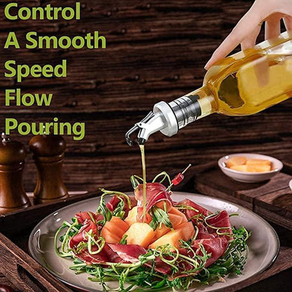 Glass oil dispenser bottle for kitchen with a controlled pouring spout over a fresh salad dish