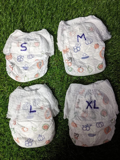 Assorted sizes of organic baby diapers in small, medium, large, and extra-large with colorful designs