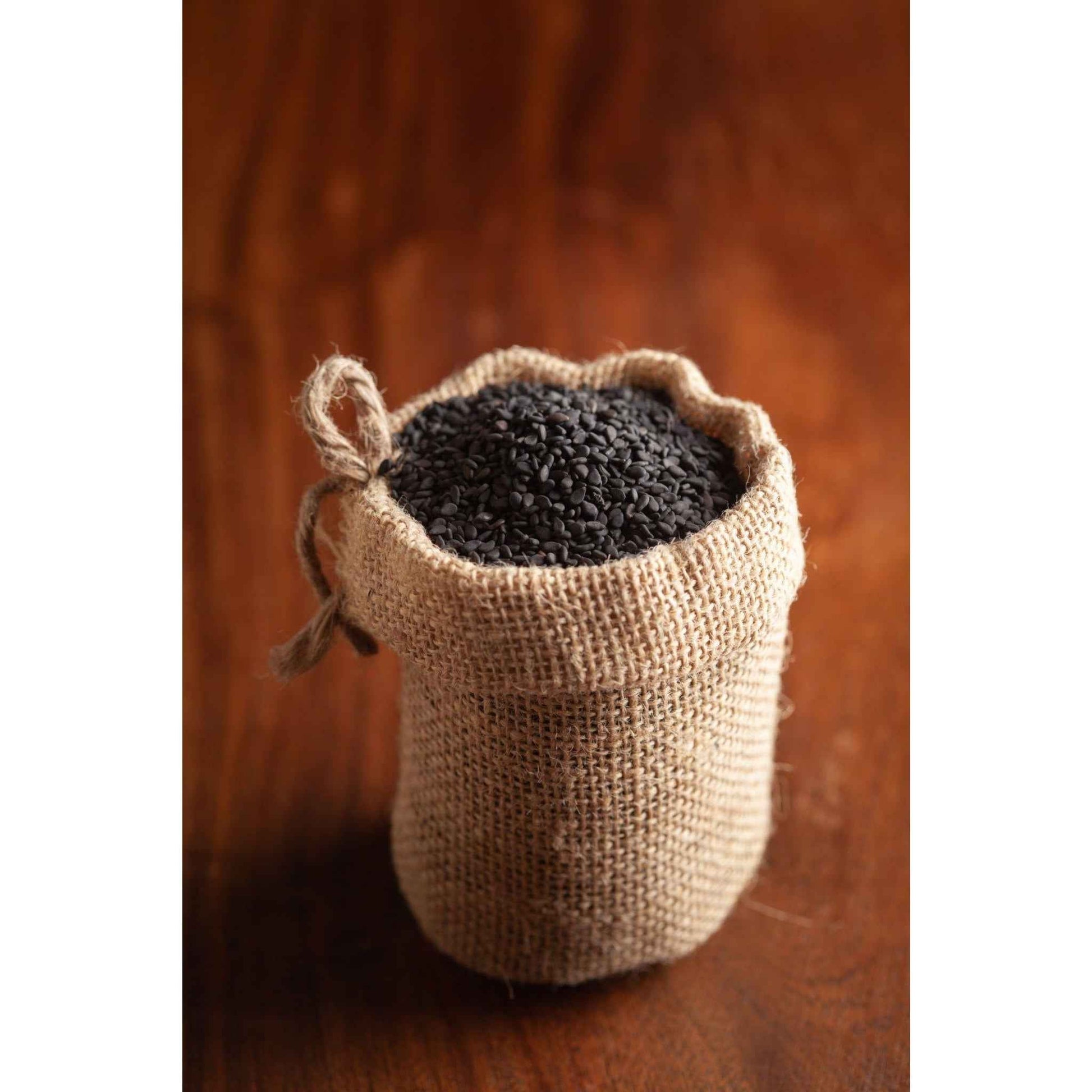 Organic Black Sesame Seeds in a burlap sack, perfect for cooking and healthy recipes