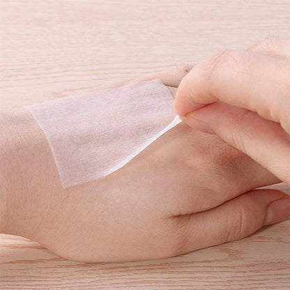 Natural organic cotton makeup remover pads gently cleansing skin on the hand with soft texture
