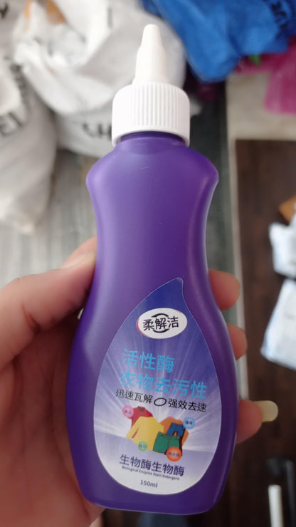 Bottle of organic fabric stain remover in purple container for effective cleaning of fabric stains