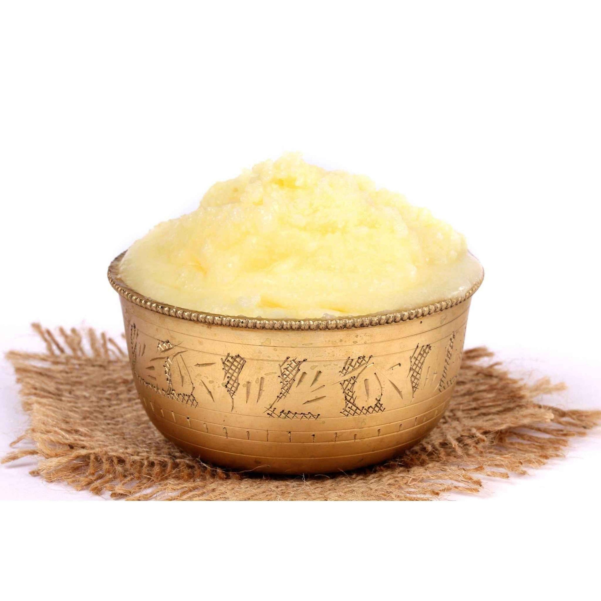 Organic ghee in a decorative brass bowl, perfect for cooking and enhancing flavors in dishes