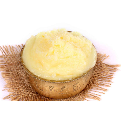 Golden organic ghee in a decorative bowl, perfect for cooking and enhancing flavors in dishes