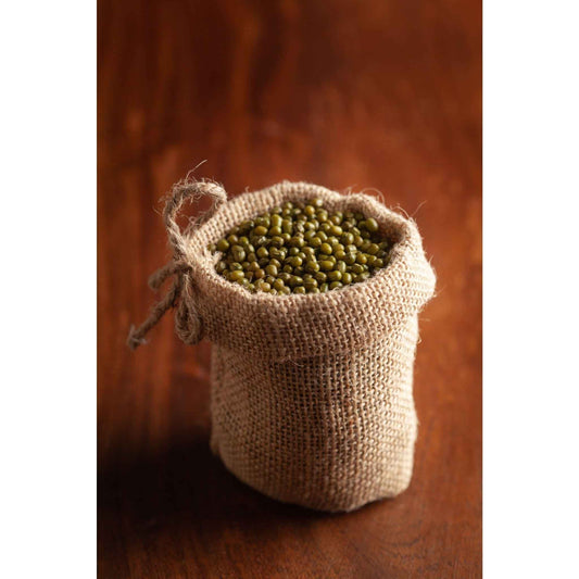 Natural burlap sack filled with organic green moong beans, perfect for healthy cooking and recipes