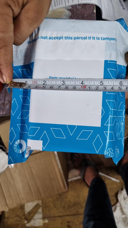 Packaging of organic potting mix being measured with a ruler for size assessment