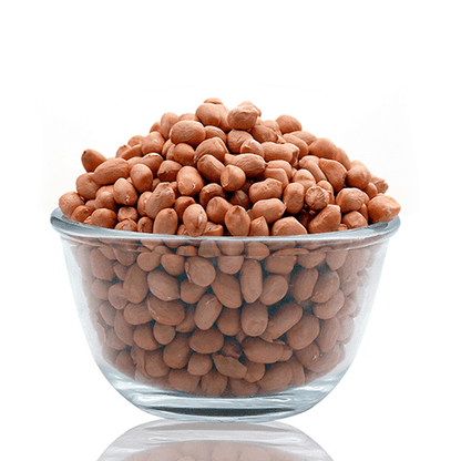 Clear glass bowl filled with organic raw peanuts from THE GIR FARMER