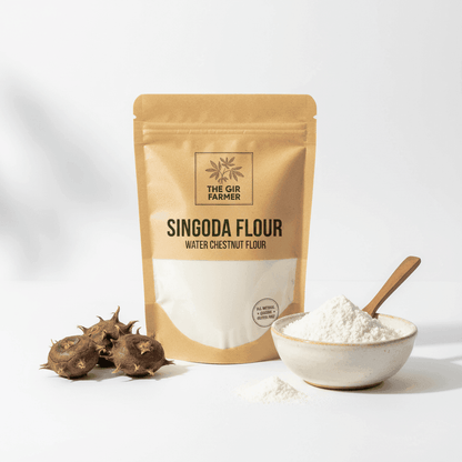 Organic Singoda Flour from The Gir Farmer in a pouch with a bowl of fine flour and water chestnuts