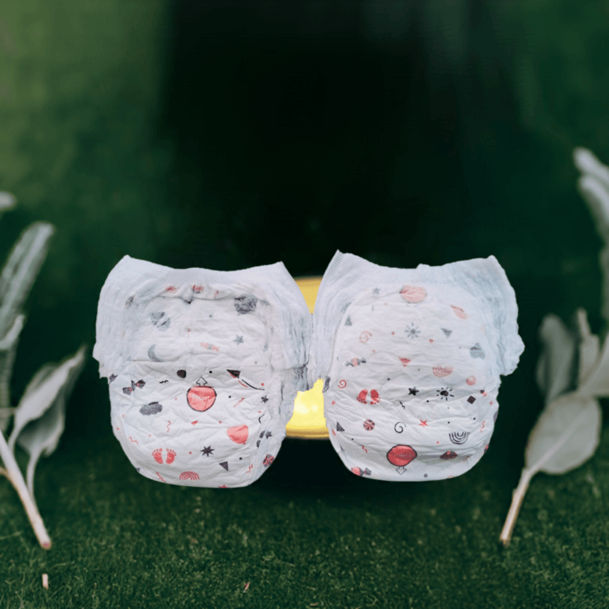 Two white organic XXL baby diapers with cute designs, perfect for keeping your baby comfortable and dry