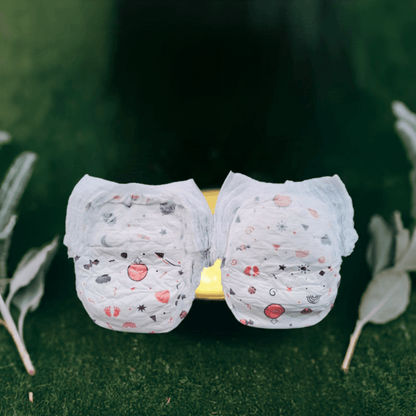 Two white organic XXL baby diapers with cute designs, perfect for keeping your baby comfortable and dry