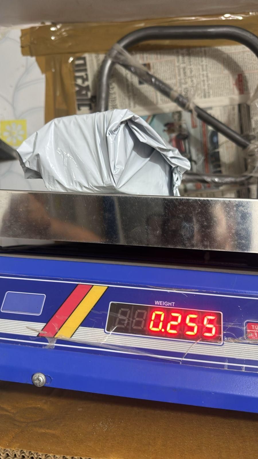 Weighing item on a scale with bee venom skin cream package visible in the background