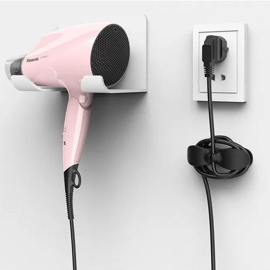 Pink hair dryer mounted on wall with appliance cable organizer for tidy storage