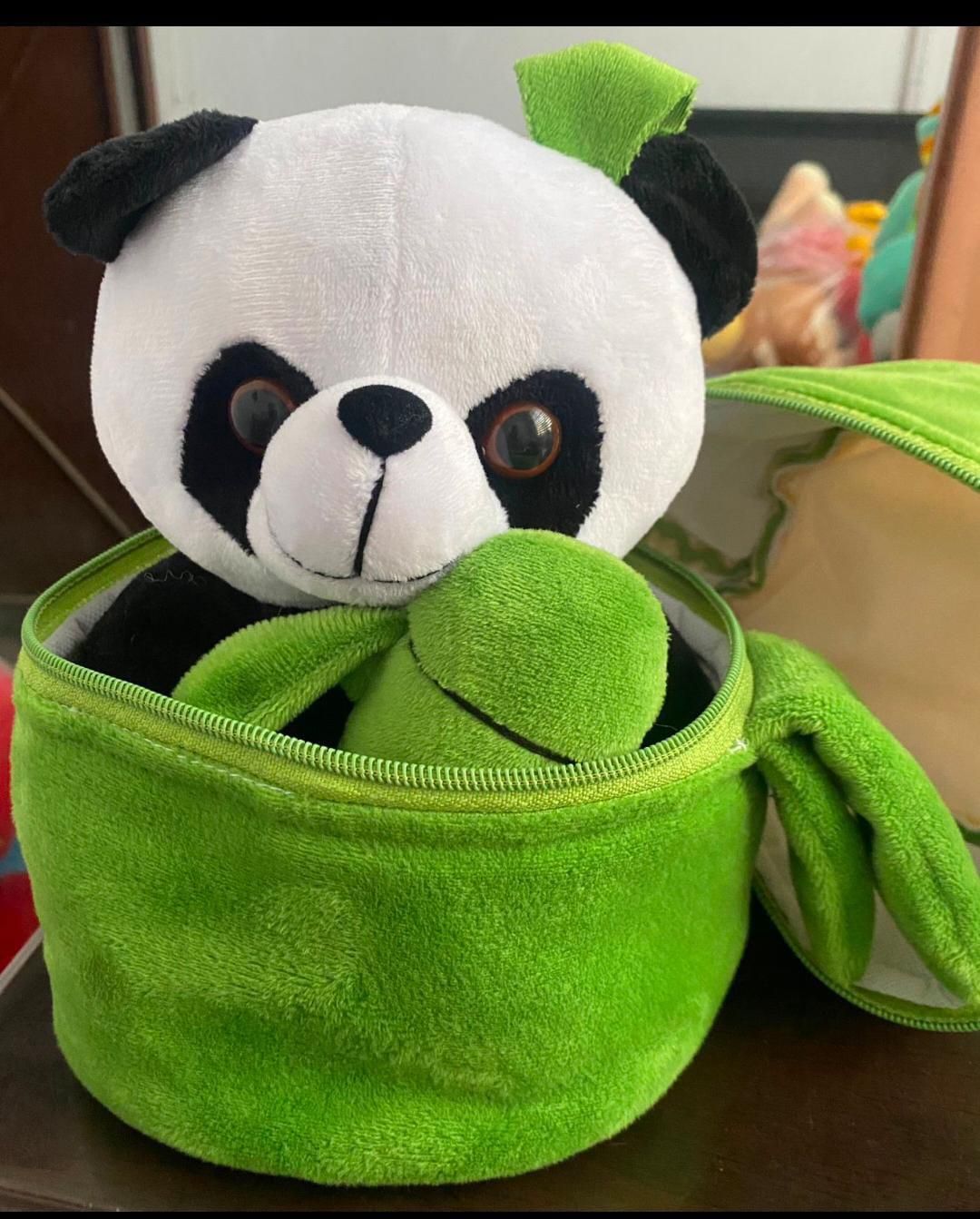Cute panda plush with bamboo inside a green storage container for kids