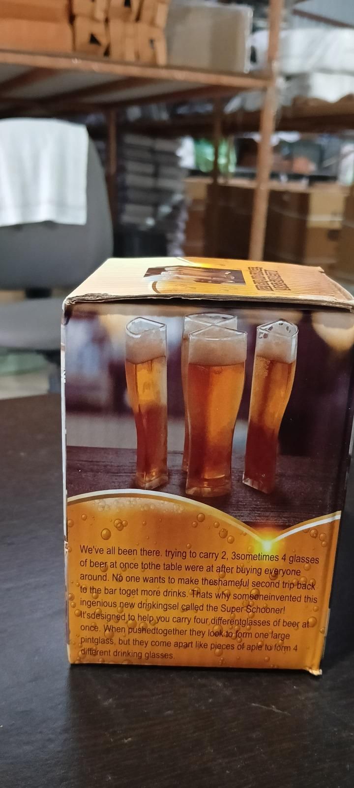 Beer splitter mug product box showing three tall beer glasses on a warehouse table and shelving