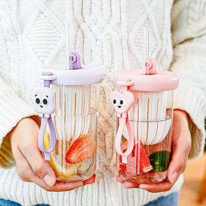 THE GIR FARMER glass smoothie tumbler with lid in pink and purple held with fresh fruit inside