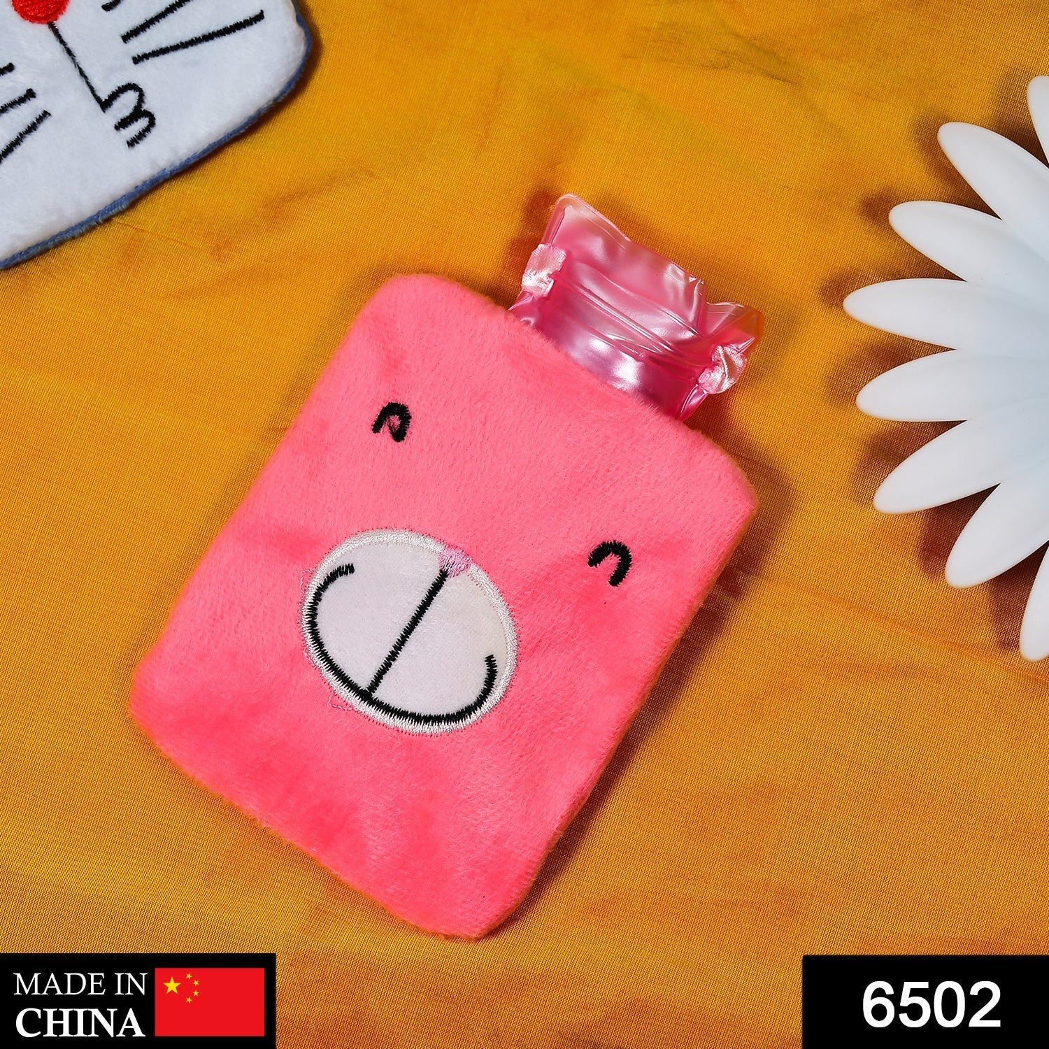 Pink hot water bag for cramps with a cute bear design and soft cover for maximum comfort