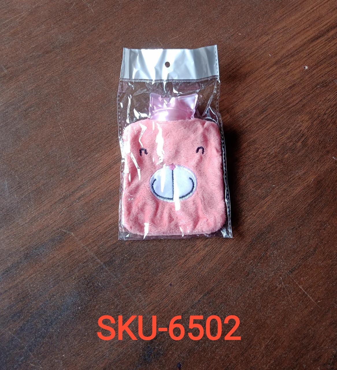 Pink hot water bag for cramps in a cute pig design, perfect for soothing relief