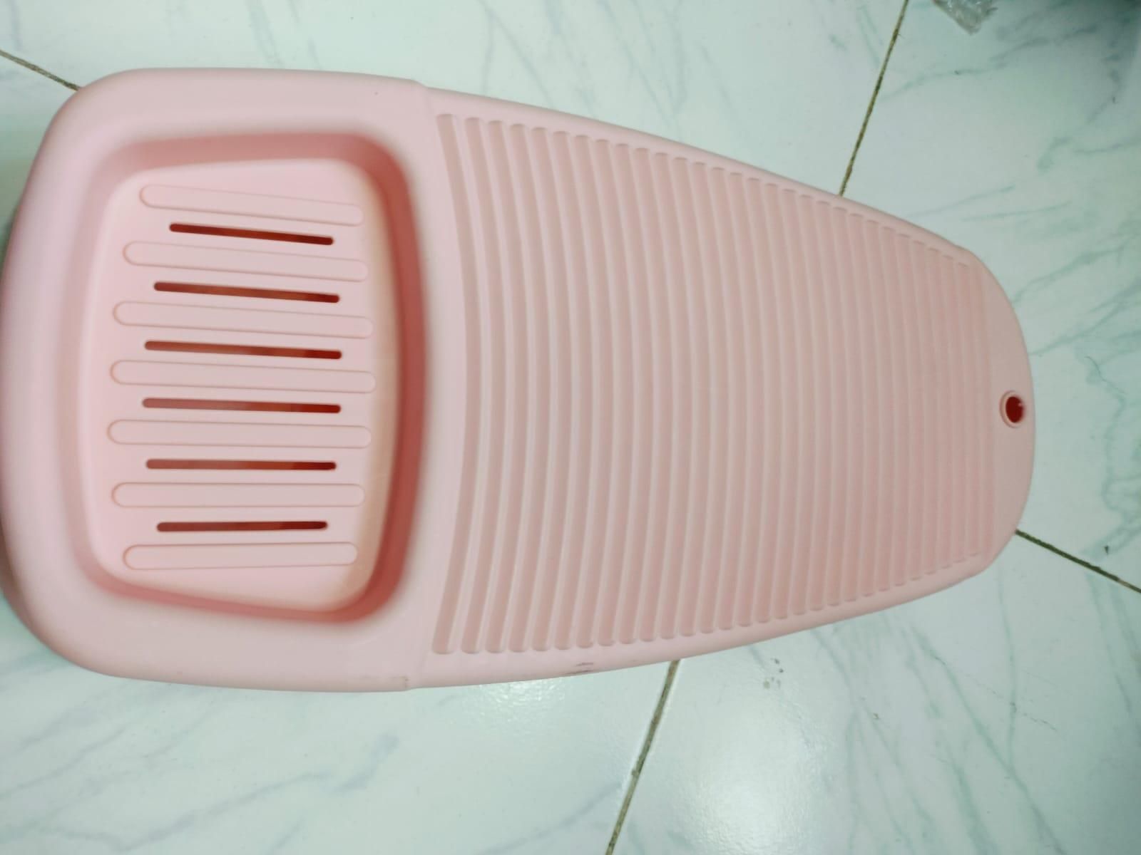Pink soap storage washboard for laundry with ridged scrubbing surface and soap holder