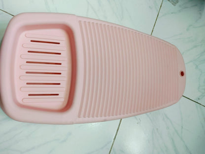 Pink soap storage washboard for laundry with ridged scrubbing surface and soap holder