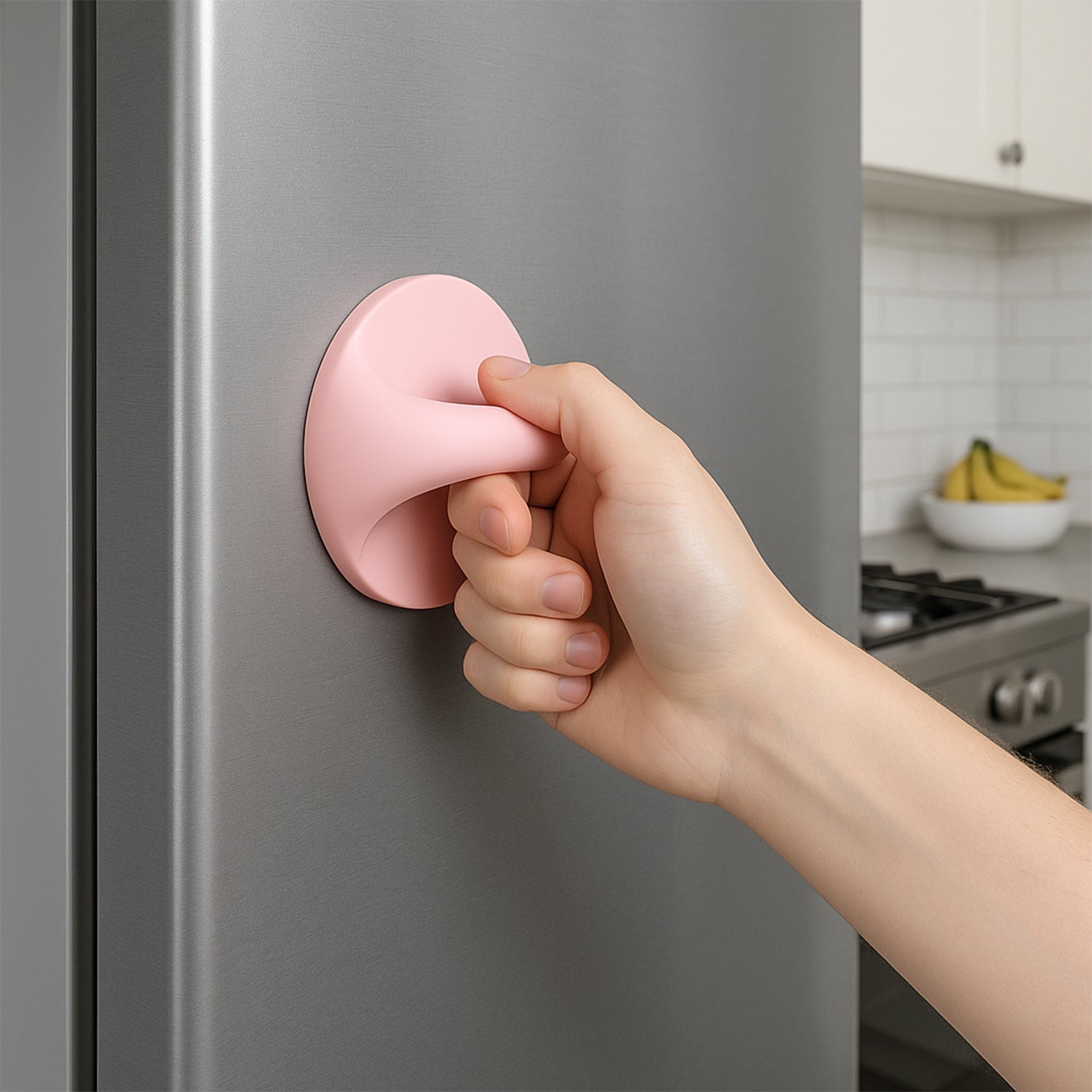 Plastic adhesive handle grip in pink being used to open a refrigerator door