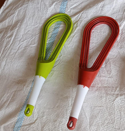 Set of two plastic balloon whisk mixers in green and red for easy food blending